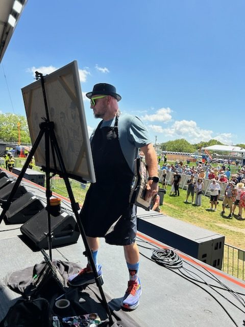 Frenchy painting live at a festival
